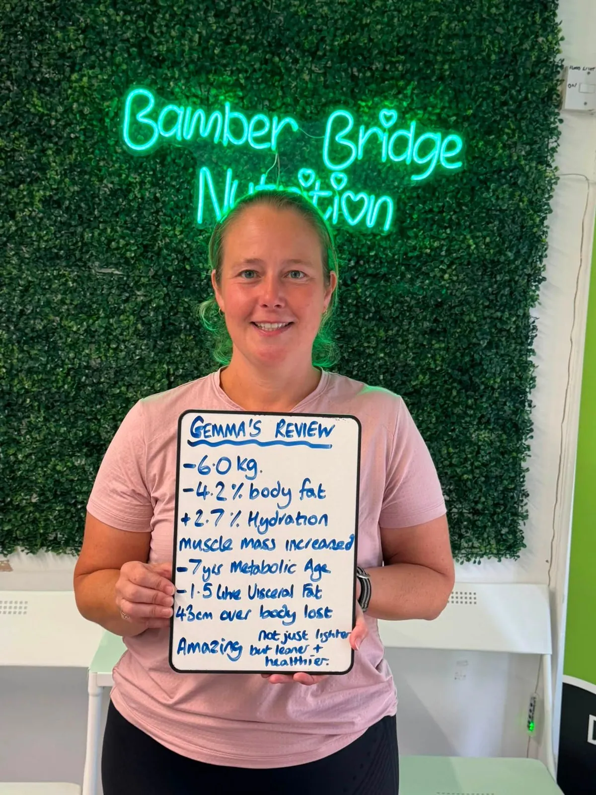 A member of Bamber Bridge Nutrition club with the whiteboard showing their results