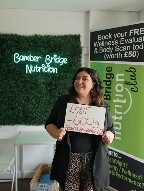 A Bamber Bridge Nutrition club member with her assessment board